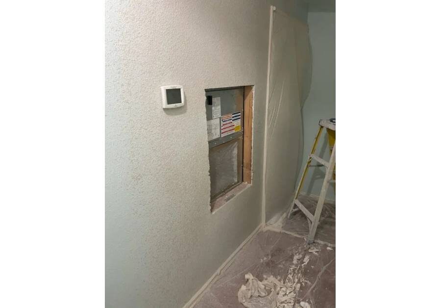 A room with walls and floors being painted.